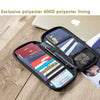 A dark blue polyester lining passport holder with various cards and a pen inside, placed on a wooden surface.