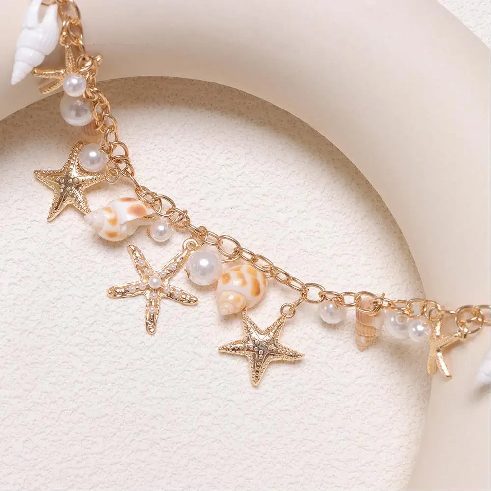 Gold layered bohemian bag chain featuring starfish and pearl charms