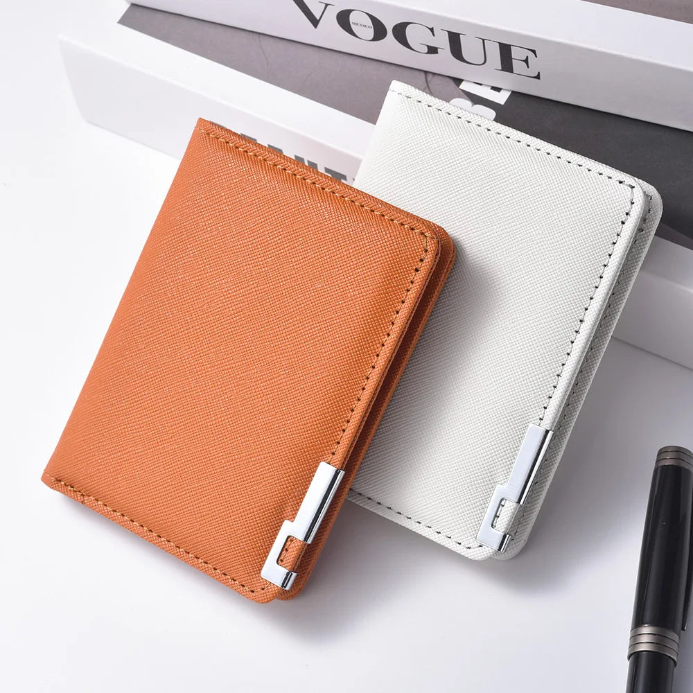 A slim vertical men's card wallet in orange and off-white colors resting on a white surface.