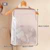 A white honeycomb mesh laundry bag is shown hanging on a wooden hanger against a light background.