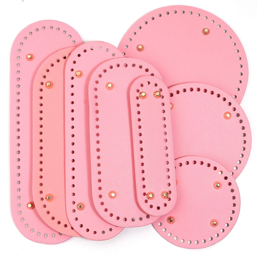 A set of pink oval PU leather bag bases with pre-punched holes for crochet and knitting projects.
