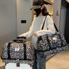 A woman holds a leopard print travel duffel bag with a shoe compartment in a modern indoor setting.