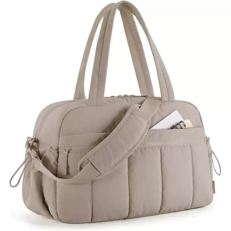 A beige versatile large capacity travel and fitness bag with padded compartments.