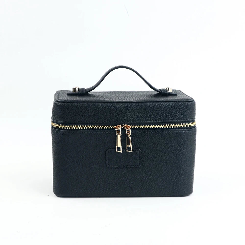 A dark navy blue PU leather makeup bag with a zipper closure and carrying loop.