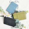 A collection of genuine leather card holders and coin purses in blue, olive green, and black tones.