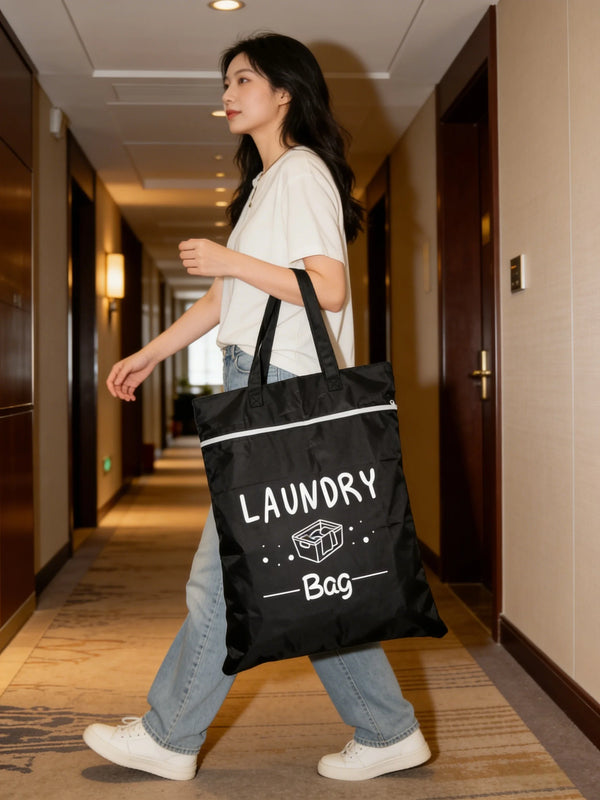 A woman walks down a hallway carrying a black laundry bag.
