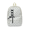 A white corduroy backpack with a bow print design and black crisscross straps.