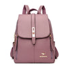 Sac à dos en cuir microfibre mauve avec accents roses et quincaillerie dorée.