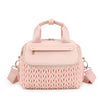 A light pink quilted mommy bag with a zipper and strap is shown from the front.