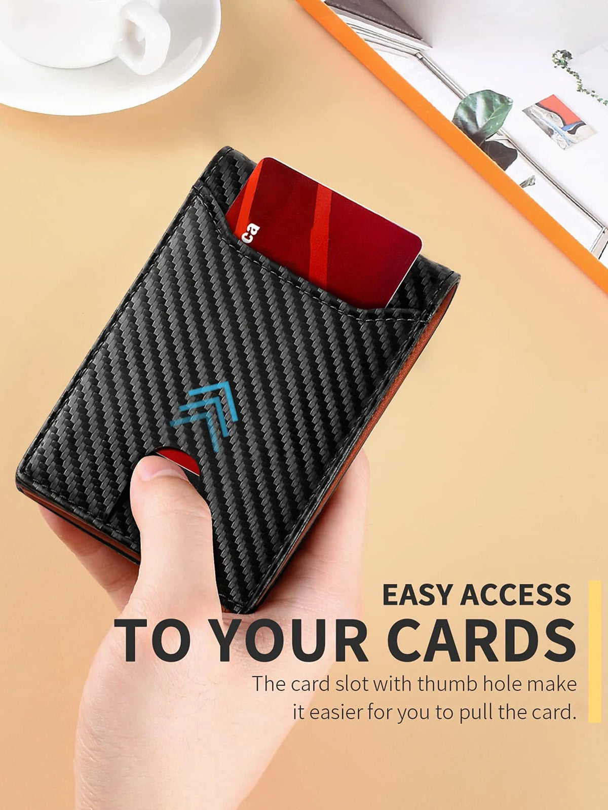 A black carbon fiber wallet with a thumb hole for easy card access is held by a hand.