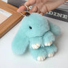 Light blue fluffy rabbit plush keychain with gold ring attached