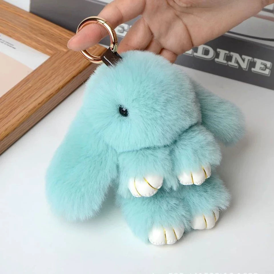 Light blue fluffy rabbit plush keychain with gold ring attached