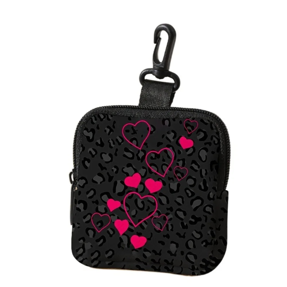 Black leopard print coin purse and multi-use earphone case with a black strap.