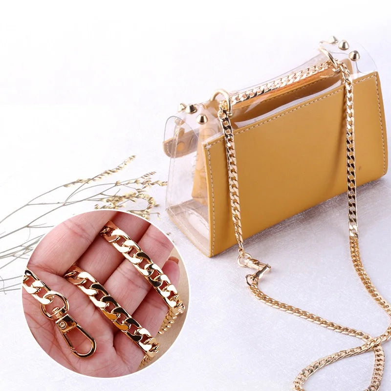 A yellow leather pouch with a gold diamond-cut curb chain strap is shown next to a hand displaying similar gold chains.