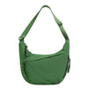 A dark green canvas crossbody bag with adjustable straps and zipper details.