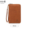 A brown leather RFID blocking passport and document holder with a strap.