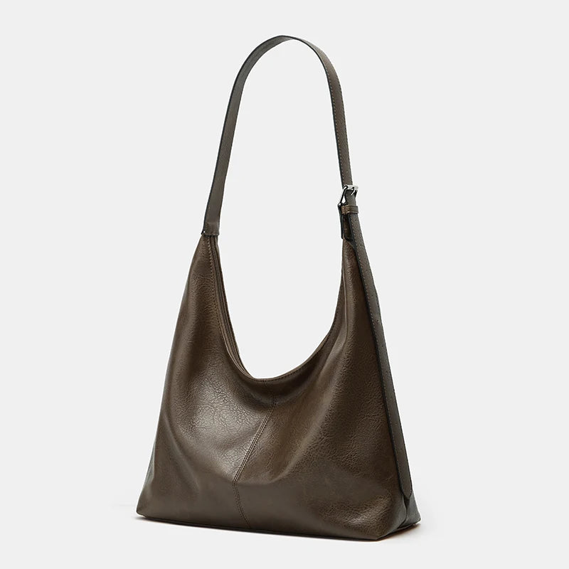 A dark brown soft PU leather retro tote bag with a long strap and zipper closure.