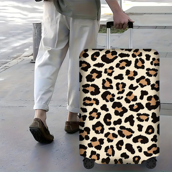 A leopard print protective luggage cover on a rolling suitcase being pulled by a person.
