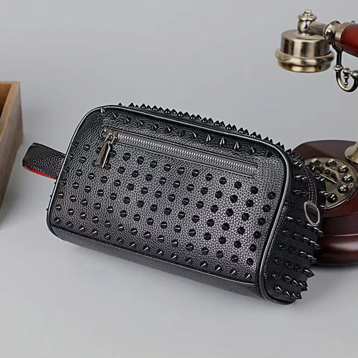 Black punk studded crossbody sling bag with a zipper and leather strap