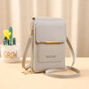 A light gray luxury women's crossbody shoulder bag with gold hardware resting on a wooden surface.