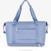 Light blue expandable travel organizer bag with padded straps shown from the back.