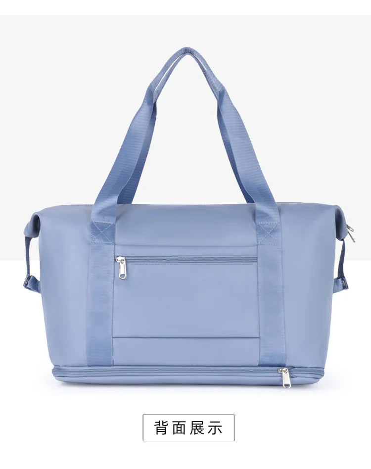 Light blue expandable travel organizer bag with padded straps shown from the back.