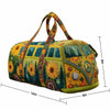 A quilted travel duffle bag featuring a vibrant floral pattern with yellow, green, and orange tones.