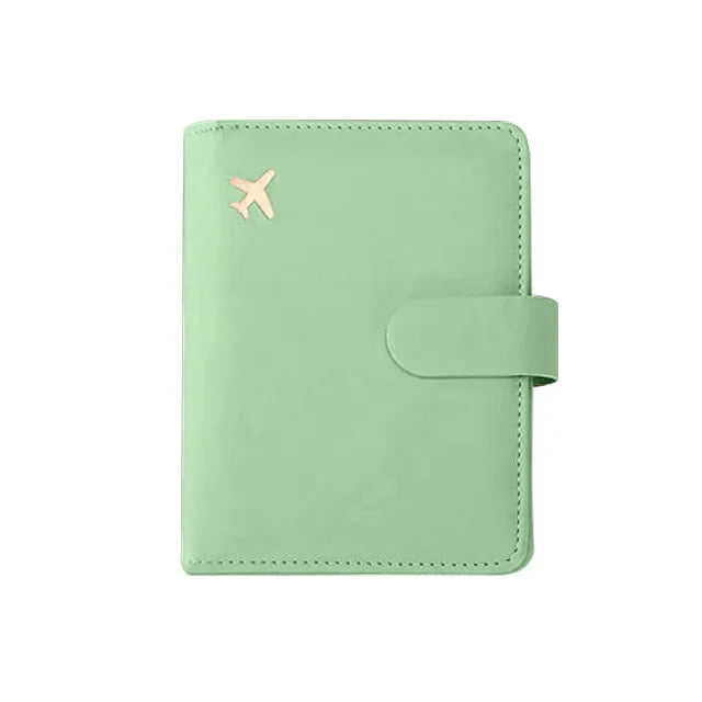 A light mint green RFID-blocking travel passport organizer with a leather cover and card slots.