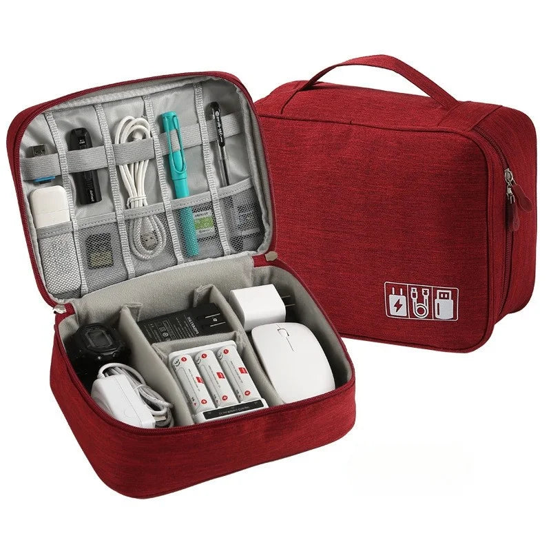 A red leather cable storage organizer bag with an open compartment showing various electronic cables and accessories.