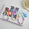 A set of colorful heart bead keychains with O-ring clips in pink, purple, and yellow shades.