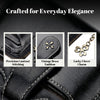 Black leather mini wallet featuring precision stitching, a vintage brass emblem, and a lucky clover charm.