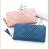 A pink quilted clutch wallet and a blue quilted clutch wallet are displayed on a white background.