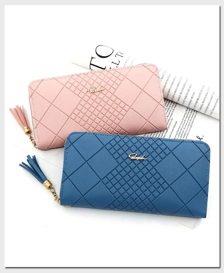 A pink quilted clutch wallet and a blue quilted clutch wallet are displayed on a white background.