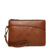 A brown retro PU leather zipper wrist bag with a leather strap.