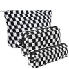 A set of three checkered black and white makeup bags.