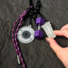 A purple nylon fitness keychain featuring a silicone fitness disc and a purple weight charm.