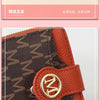 A brown leather compact wallet with a gold logo detail and a patterned cover.