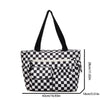 A black and white checkered stripe pattern corduroy tote bag with black handles.