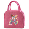 A pink insulated canvas lunch bag featuring a large blue letter A decorated with floral elements.