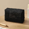 Black lace mesh cosmetic and jewelry organizer bag resting on a wooden surface.