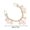 Accesorio de bolso con cadena tono dorado, charmes de corazón y flor de cerezo en esmalte