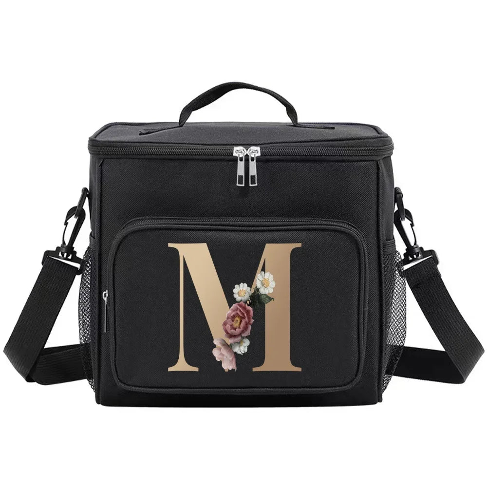 Black insulated canvas lunch bag with dual handles featuring a gold initial M and floral accents.