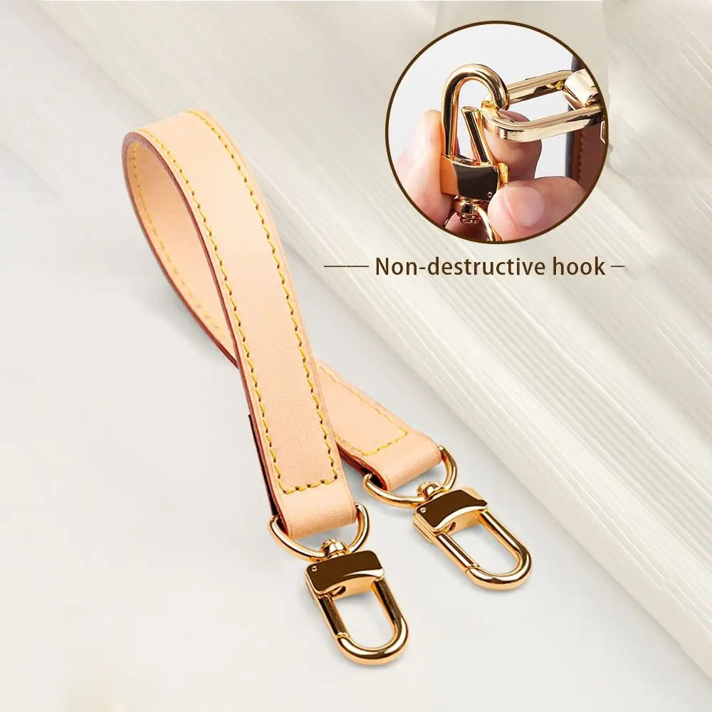 A light tan genuine leather replacement shoulder strap with a non-destructive hook is shown against a white background.