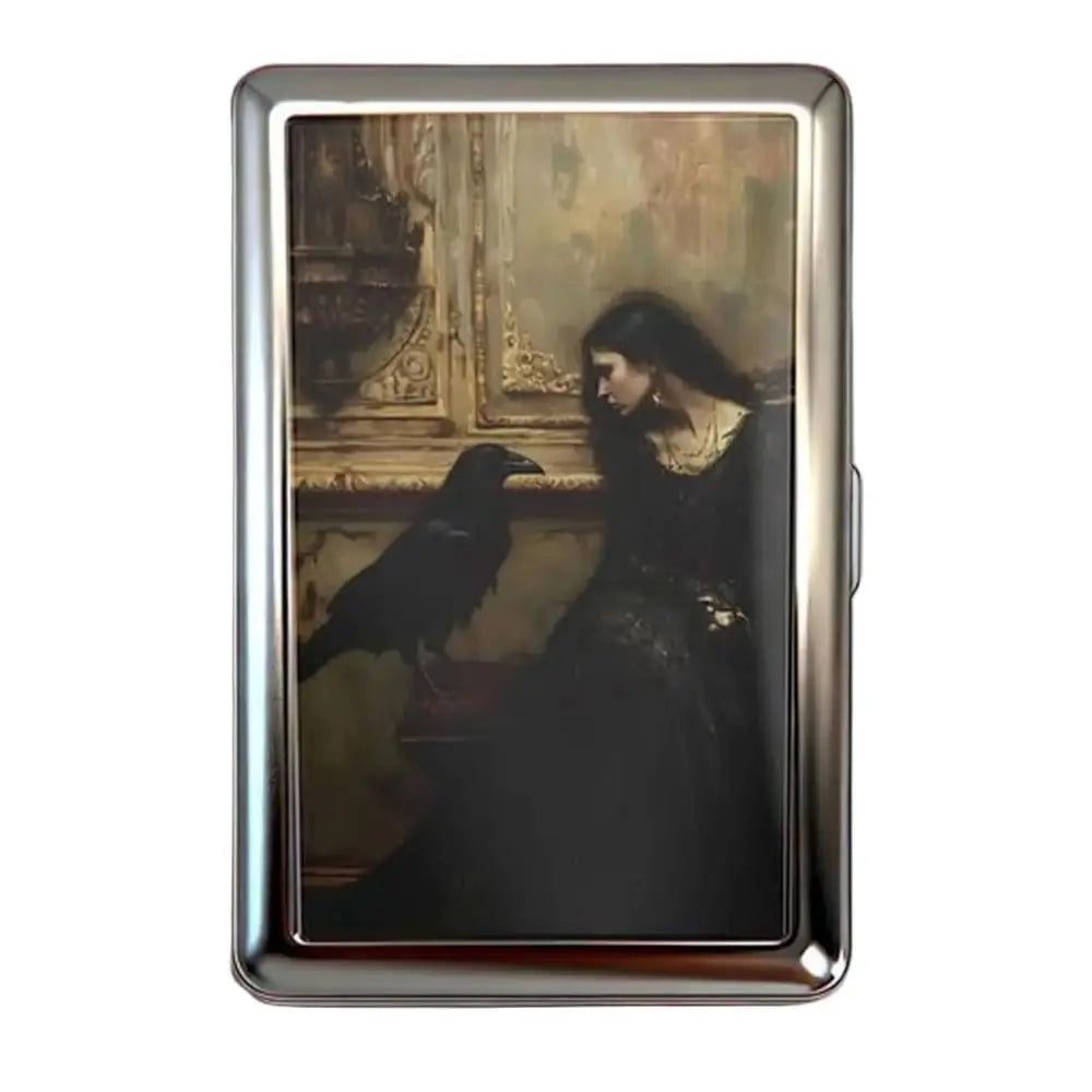 A vintage snap metal card holder featuring a dark portrait of a bird on a gilded background.