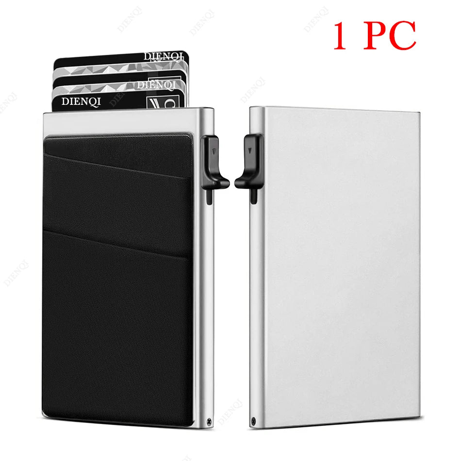 A silver metal card holder with a black sleeve and a stack of cards is shown.