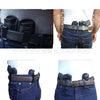A close-up of a black leather holster and belt system designed for concealed carry inside the waistband.