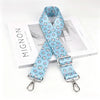 Light blue floral patterned nylon crossbody bag strap with a silver metal buckle