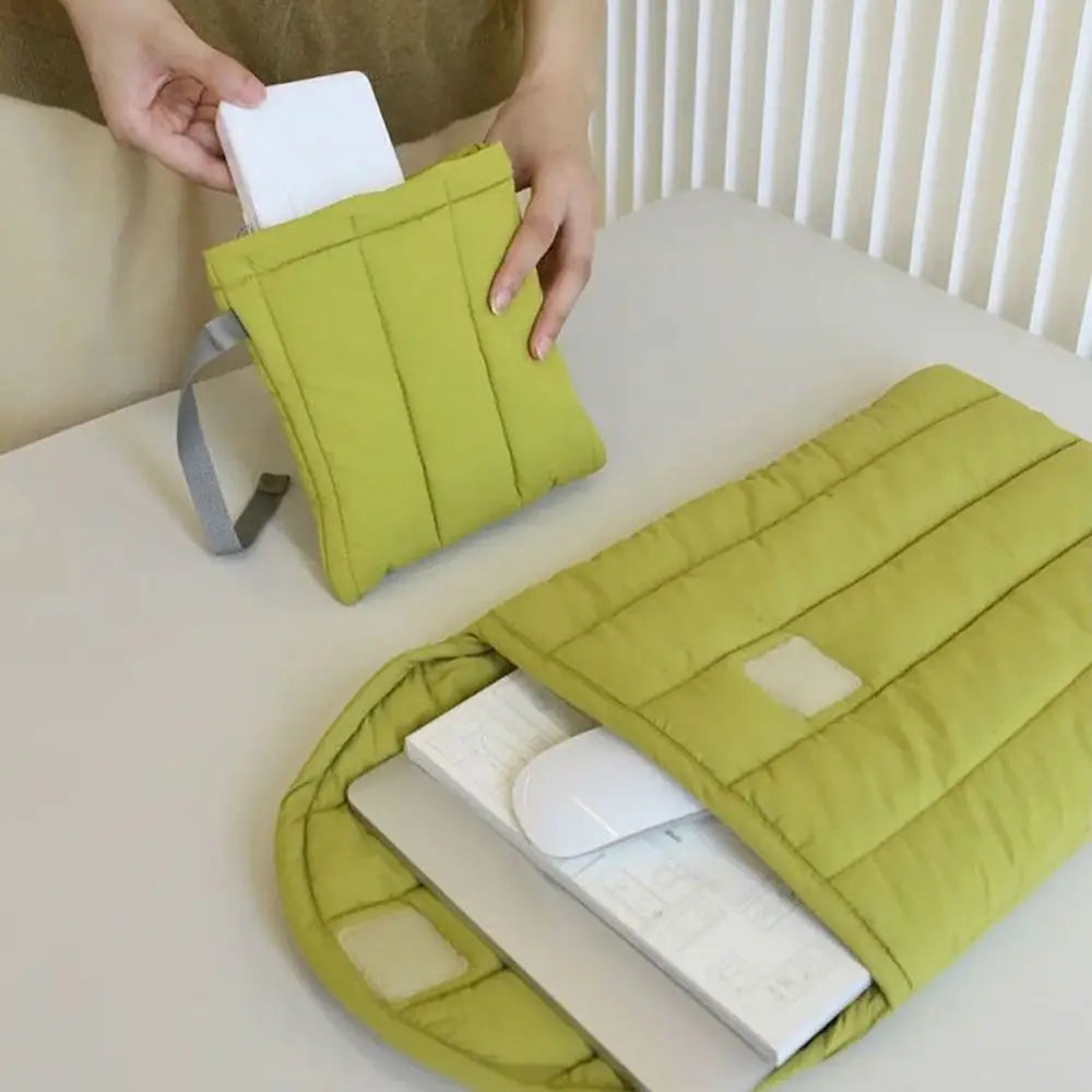 A lime green embroidered cotton laptop sleeve is shown open, displaying a white laptop inside.