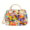 A multi-color abstract splatter pattern lunch bag with tan straps and a brown patch featuring the word Heopono.