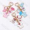 A set of cartoon infusion pump thermometer keychains in pink, blue, and white for medical professionals